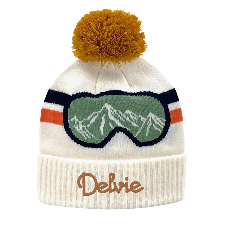 The Delvie Goggle Peak Knit Pom Beanie
